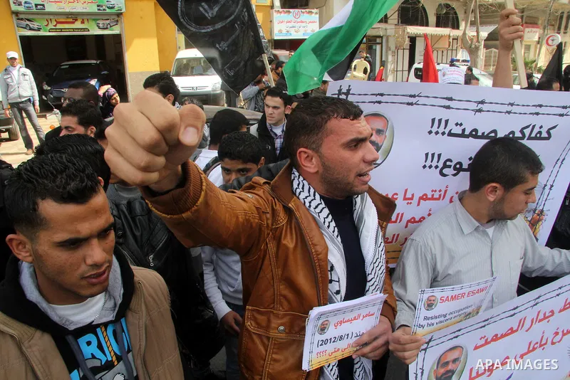 Palestinians take part in a protest against the death of a Palestinian detainee in an Israeli jail, in Gaza City February 25, 2013. Palestinian officials on Saturday demanded an international investigation into the death...