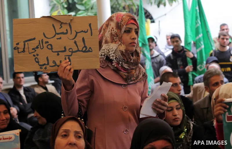 Palestinian women hold pictures of prisoners held in the Israeli jails during a protest calling for the release of Palestinian prisoners from Israeli jails in front of the Red cross office in Gaza city, on February 25, 2...