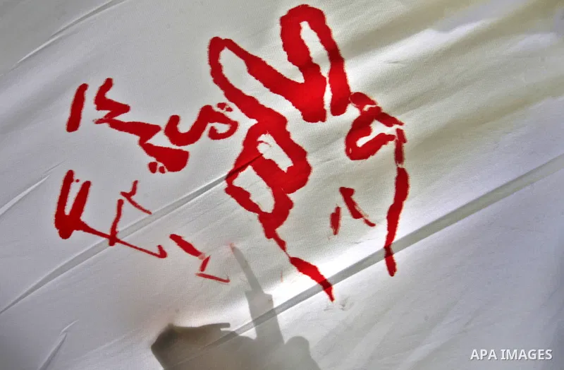 Palestinians write letters in blood on a banner during a demonstration in support of the Palestinian prisoners in Israeli jails, in the city of Nablus, in the occupied West Bank, on February 25, 2013. Protests in support...