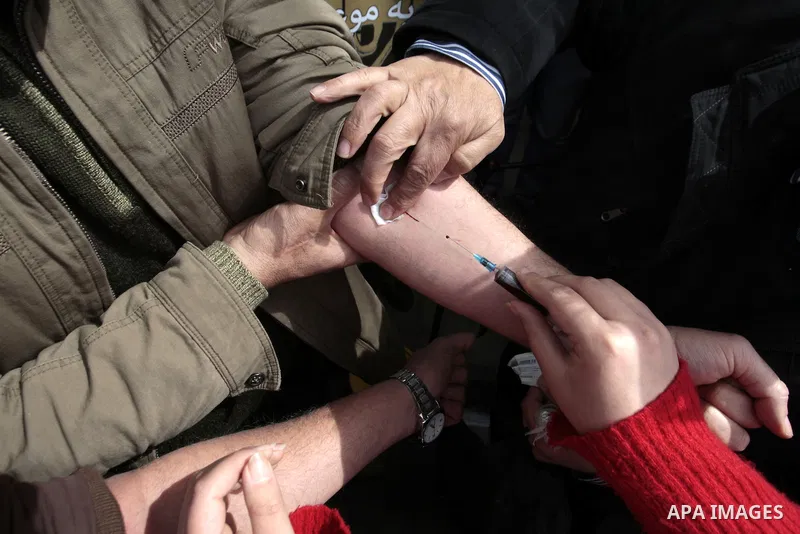 Palestinians write letters in blood on a banner during a demonstration in support of the Palestinian prisoners in Israeli jails, in the city of Nablus, in the occupied West Bank, on February 25, 2013. Protests in support...