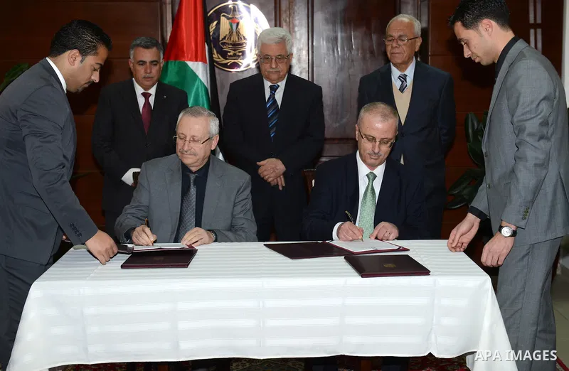 Palestinian President Mahmoud Abbas attends the signing ceremony of a new agreement between the Ministry of Health and the national hospital of al-Najah University, in the West bank city of Ramallah on February 25, 2013....
