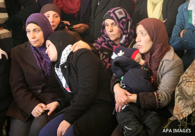 Palestinian relatives of Arafat Jaradat mourn during his funeral in the West Bank village of Se'eer, near Hebron February 25, 2013. Jaradat's death in an Israeli jail on Saturday and a hunger strike by four other Palesti...