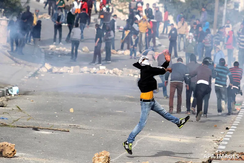 Palestinian protesters throw stones at Israeli border police during clashes in the village of Saair near the West Bank city of Hebron, on February 25, 2013. Palestinians attended the funeral of Arafat Jaradat, 30, whose...