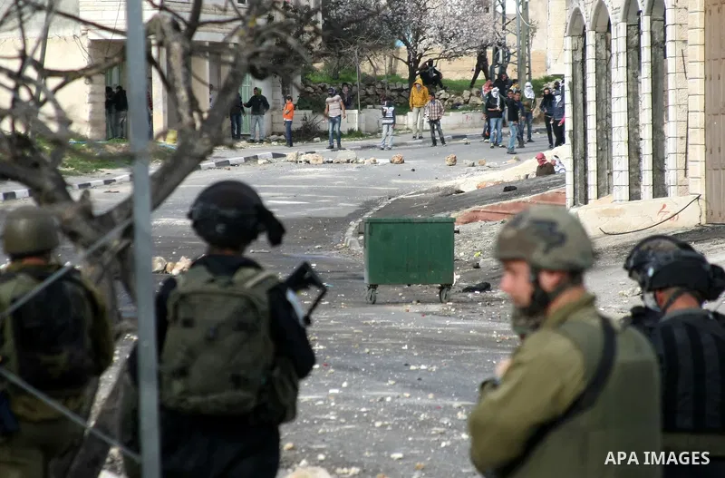 Israeli border police stand apposite Palestinian protesters during clashes in the village of Saair near the West Bank city of Hebron, on February 25, 2013. Palestinians attended the funeral of Arafat Jaradat, 30, whose d...