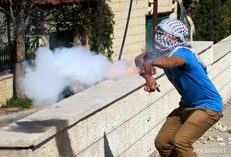 A Palestinian protestor aims sparks from a flare towards Israeli security forces during clashes in al-Aroob refugee camp near the West Bank town of Hebron on February 26, 2013. Increased protests in the West Bank after t...