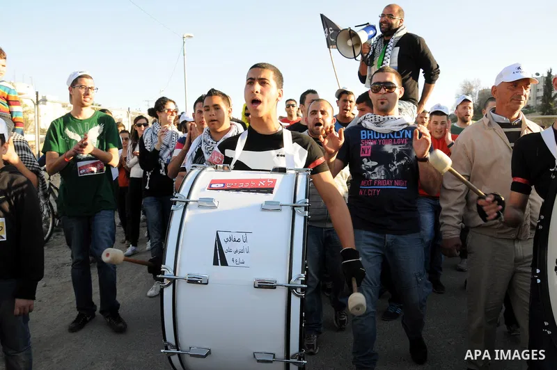 Palestinians take part in a protest against the opening project of the street number (4) in the middle of Bet Safafa neighbourhood, which is for settlement project services, in Jerusalem on February 26, 2013. Photo by Ma...