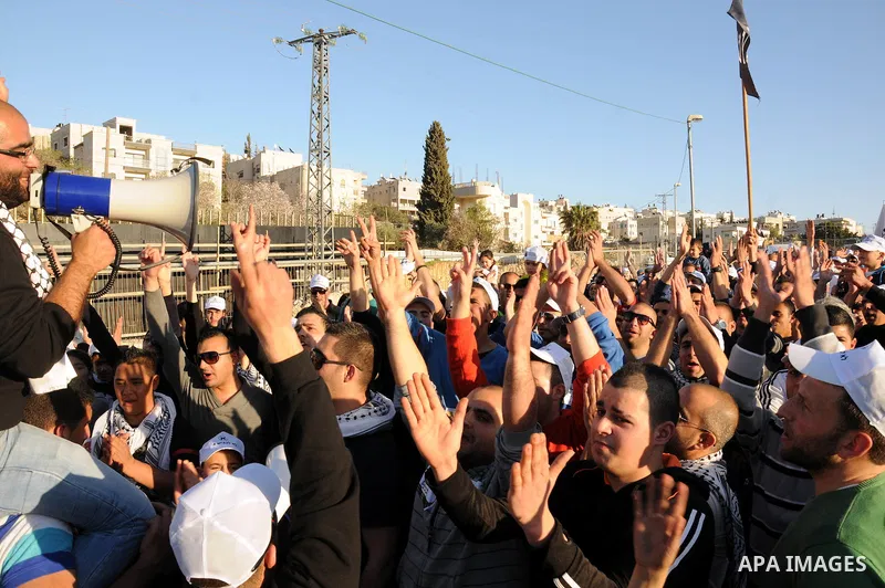 Palestinians take part in a protest against the opening project of the street number (4) in the middle of Bet Safafa neighbourhood, which is for settlement project services, in Jerusalem on February 26, 2013. Photo by Ma...