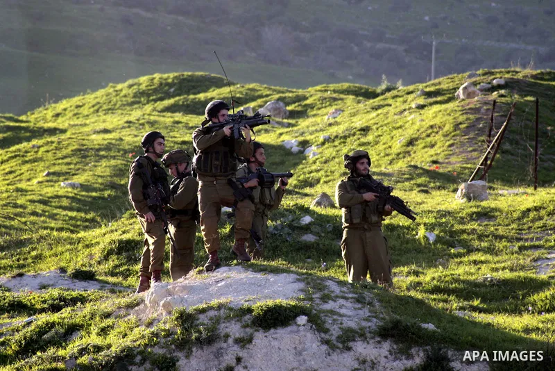 Israeli security forces fire tear gas at Palestinian protesters during clashes at Hawwara military checkpoint near the West Bank city of Nablus on February 26, 2013. Increased protests in the West Bank after the killing...