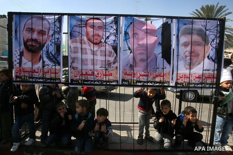 Palestinian children take part in a protest against the death of a Palestinian detainee in an Israeli jail, in Rafah city in the southern Gaza Strip on Feb. 27, 2013. Palestinian officials on Saturday demanded an interna...