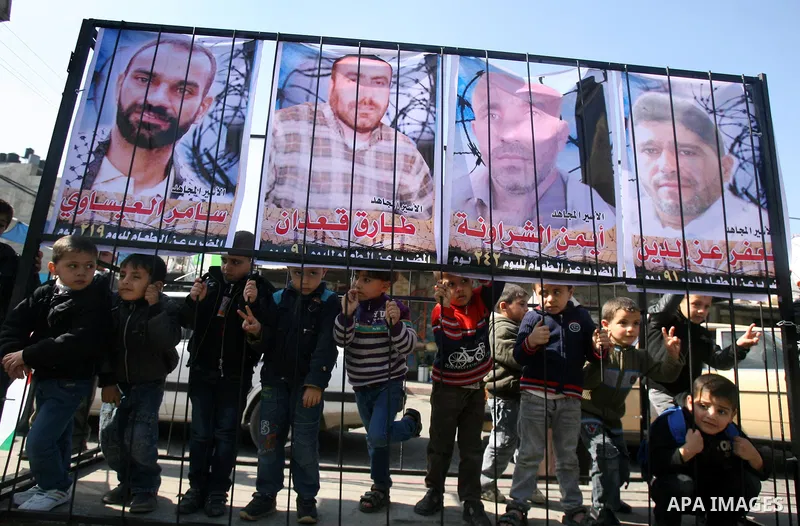 Palestinian children take part in a protest against the death of a Palestinian detainee in an Israeli jail, in Rafah city in the southern Gaza Strip on Feb. 27, 2013. Palestinian officials on Saturday demanded an interna...