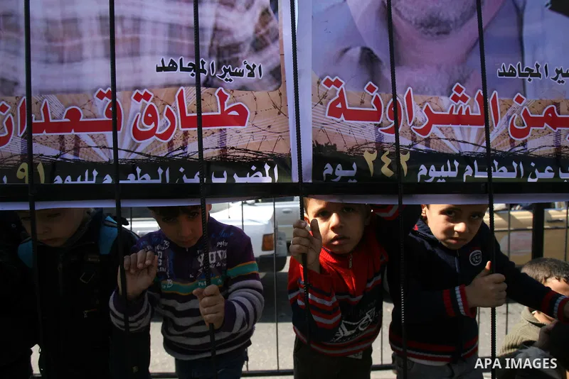 Palestinian children take part in a protest against the death of a Palestinian detainee in an Israeli jail, in Rafah city in the southern Gaza Strip on Feb. 27, 2013. Palestinian officials on Saturday demanded an interna...