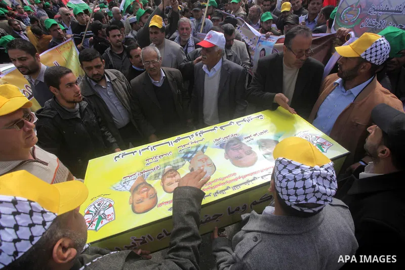 Demonstrators from the Palestinian factions take part in a protest against the death of a Palestinian detainee in an Israeli jail, in front of the Erez crossing into Israel near the northern Gaza Strip town of Beit Hanun...