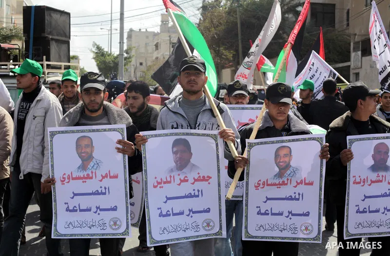 Demonstrators from the Palestinian factions take part in a protest against the death of a Palestinian detainee in an Israeli jail, in front of the Erez crossing into Israel near the northern Gaza Strip town of Beit Hanun...