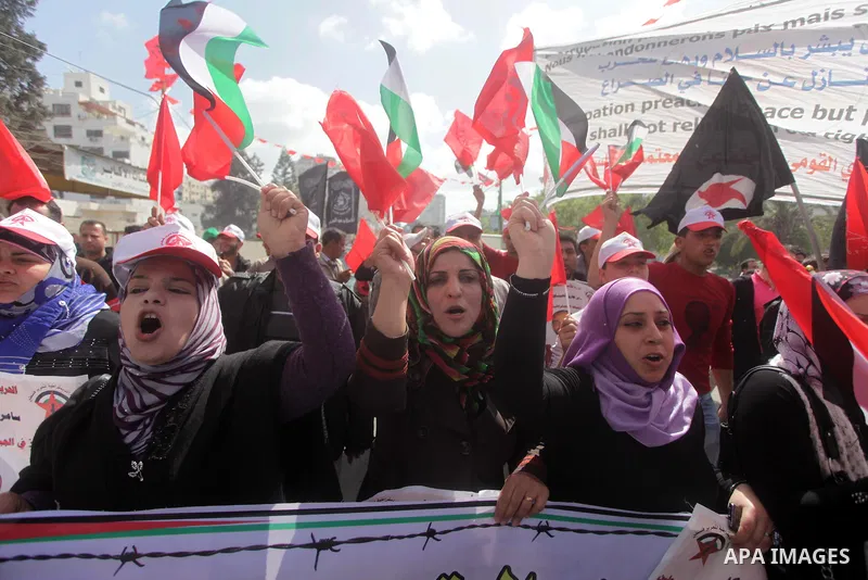Demonstrators from the Palestinian factions take part in a protest against the death of a Palestinian detainee in an Israeli jail, in front of the Erez crossing into Israel near the northern Gaza Strip town of Beit Hanun...