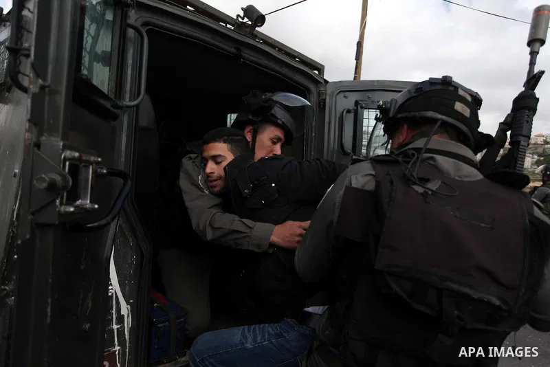 Israeli security forces detain a Palestinian protester during clashes near Israeli military prison Ofer, south of the West Bank city of Ramallah, 28 February 2013. Hunger strikes by Palestinians in Israeli prisons have s...
