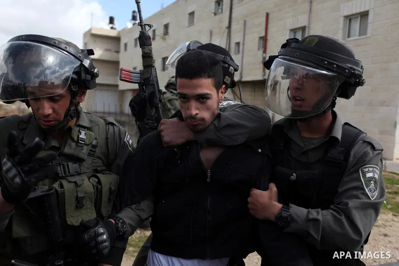 Israeli security forces detain a Palestinian protester during clashes near Israeli military prison Ofer, south of the West Bank city of Ramallah, 28 February 2013. Hunger strikes by Palestinians in Israeli prisons have s...