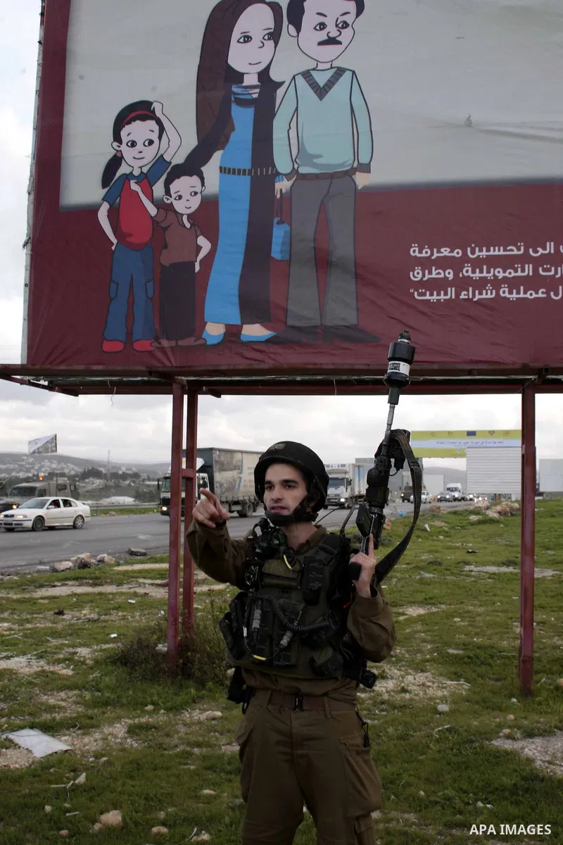 An Israeli soldier takes position during clashes with Palestinian protesters near Huwwara checkpoint, near Nablus, West Bank, 28 February 2013. Hunger strikes by Palestinians in Israeli prisons have sparked clashes throu...