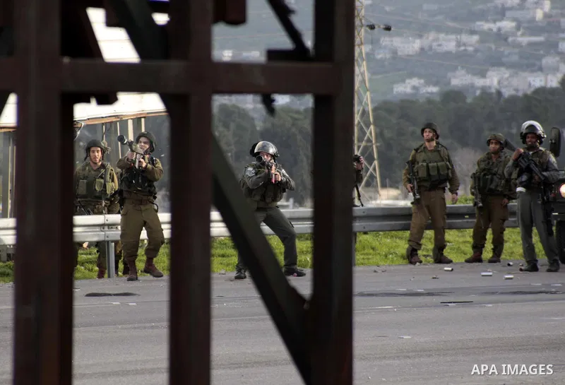 Israeli soldiers fire tear gas during clashes with Palestinian protesters near Huwwara checkpoint, near Nablus, West Bank, 28 February 2013. Hunger strikes by Palestinians in Israeli prisons have sparked clashes througho...