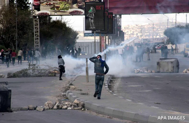 A Palestinian protester throws back a tear gas canister fired by Israeli security forces during clashes near Huwwara checkpoint, near the West Bank city of Nablus, 28 February 2013. Hunger strikes by Palestinians in Isra...