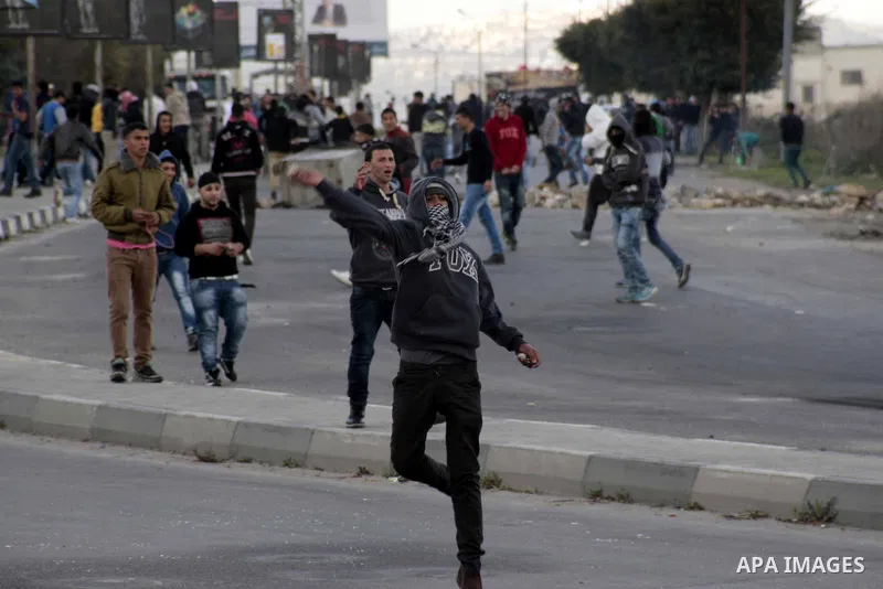 Palestinian protesters throw stones at Israeli security forces during clashes near Huwwara checkpoint, near the West Bank city of Nablus, 28 February 2013. Hunger strikes by Palestinians in Israeli prisons have sparked c...