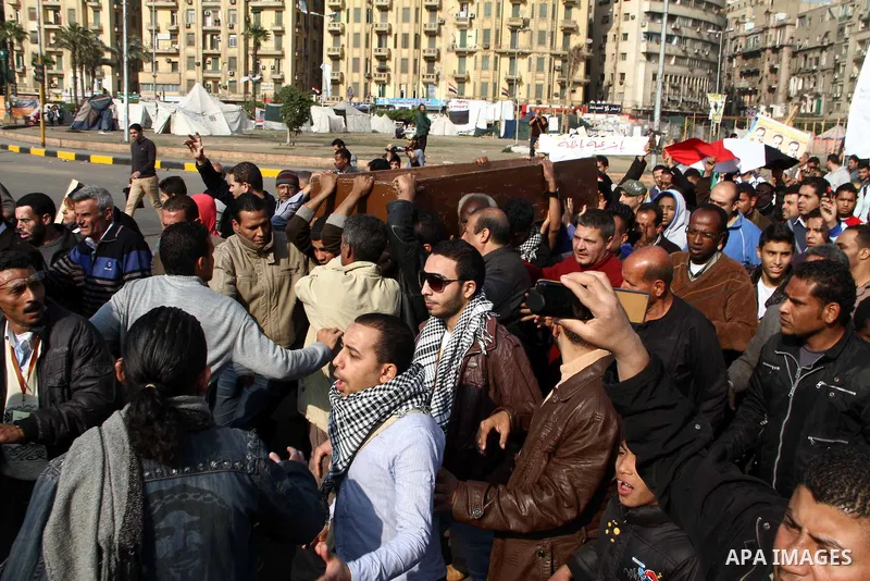 Egyptian mourners carry the coffin of Egyptian activist Mohamed al-Shafie during his funeral in Cairo, Egypt, 05 March 2013. According to local media sources, clashes broke out between mourners and police forces during t...