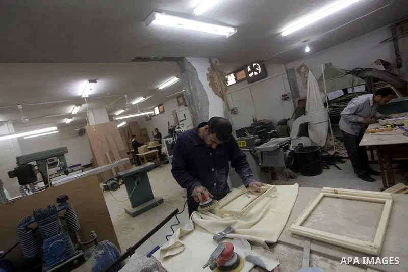 Deaf Palestinian men work on joinery at Atfaluna Society for Deaf Children in Gaza City, on 6 March, 2013. The society provides services for about 15,000 deaf children and adults on education, training programs and incom...