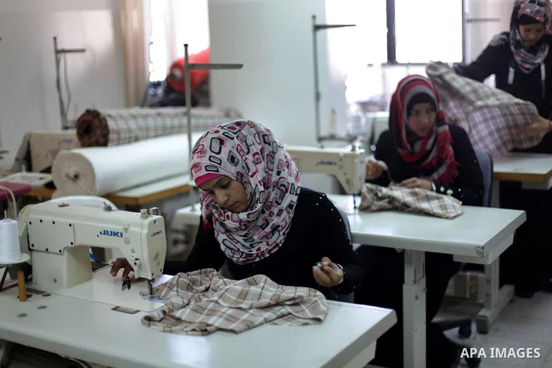 Deaf Palestinian men work on sewing at Atfaluna Society for Deaf Children in Gaza City, on 6 March, 2013. The society provides services for about 15,000 deaf children and adults on education, training programs and income...