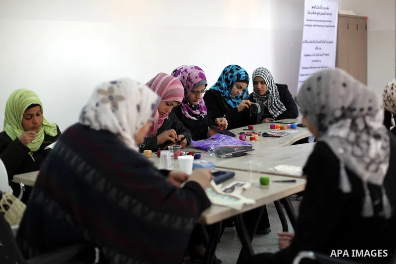 Deaf Palestinian women work on embroidery at Atfaluna Society for Deaf Children in Gaza City, on 6 March, 2013. The society provides services for about 15,000 deaf children and adults on education, training programs and...