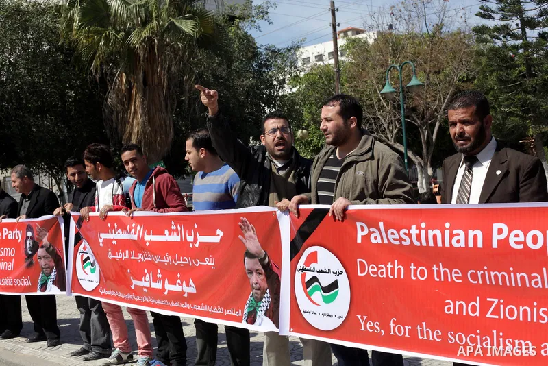 Palestinian factions hold portraits of late Venezuelan president Hugo Chavez during a rally in the Square of the unknown Soldier in Gaza city on march 07, 2013. Chavez died on 05 March from complications related to cance...