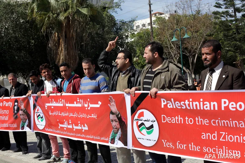 Palestinian factions hold portraits of late Venezuelan president Hugo Chavez during a rally in the Square of the unknown Soldier in Gaza city on march 07, 2013. Chavez died on 05 March from complications related to cance...