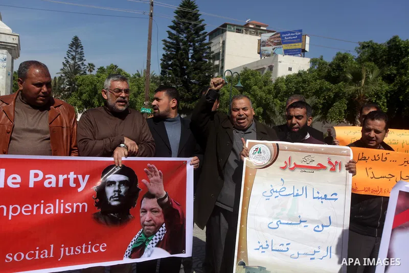 Palestinian factions hold portraits of late Venezuelan president Hugo Chavez during a rally in the Square of the unknown Soldier in Gaza city on march 07, 2013. Chavez died on 05 March from complications related to cance...
