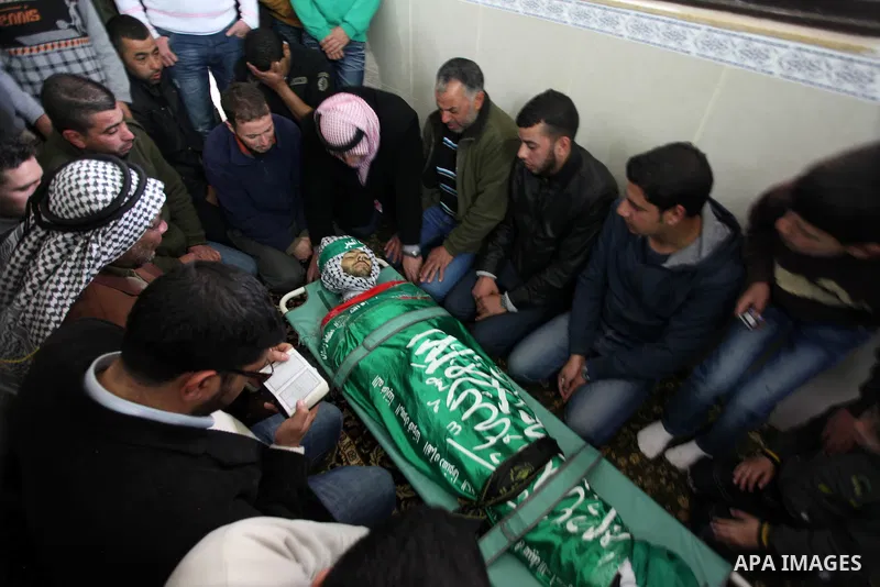 Palestinians mourn over the body of Mohammed Asfour, 22, during his funeral in the West Bank village of Aboud near Ramallah March 8, 2013. Asfour, shot by Israeli soldiers during a confrontation with stone-throwers in th...