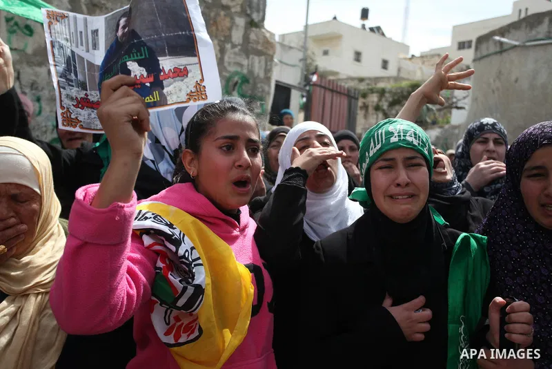 Palestinian relatives of Mohammed Asfour, 22, mourn during his funeral in the West Bank village of Aboud near Ramallah March 8, 2013. Asfour, shot by Israeli soldiers during a confrontation with stone-throwers in the occ...