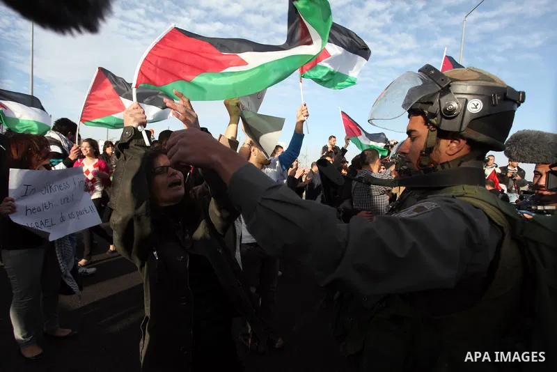 Israeli soldiers prevent the progress of a symbolic wedding party towards the Israeli constructed controversial separation barrier close to the Israeli manned checkpoint of Hezma in the Israeli occupied West Bank, betwee...