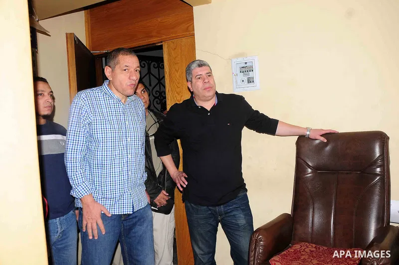 Egyptians inspect the headquarters of the Egyptian Football Association in Cairo on march 10, 2013. The headquarters of the Egyptian Football Association in Cairo were set ablaze by fans of the local Al-Ahly team who had...