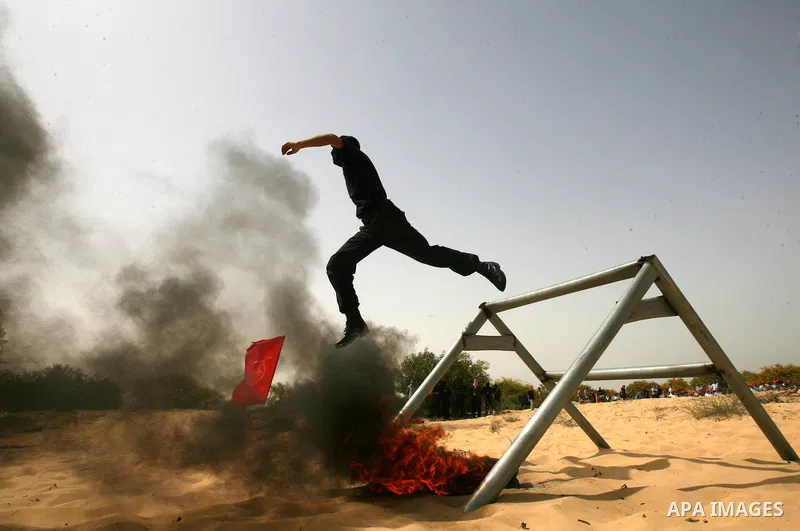 Palestinian militants of the Popular Front for the Liberation of Palestine (PFLP) demonstrate their skills during a military graduation ceremony in front of the media in Khan Younis in the southern Gaza Strip March 13, 2...