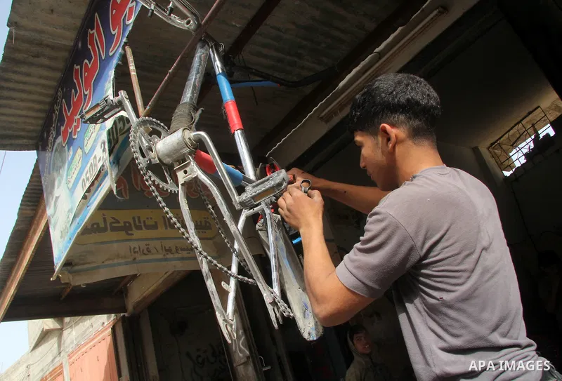 Khamis al-Burdini, 15, a Palestinian youth repairs bicycles at his workshop in Gaza city, on March 13, 2013. al-Burdini opened his workshop 3 years ago after leaving his school to provide his poor family . Photo by Ezz a...