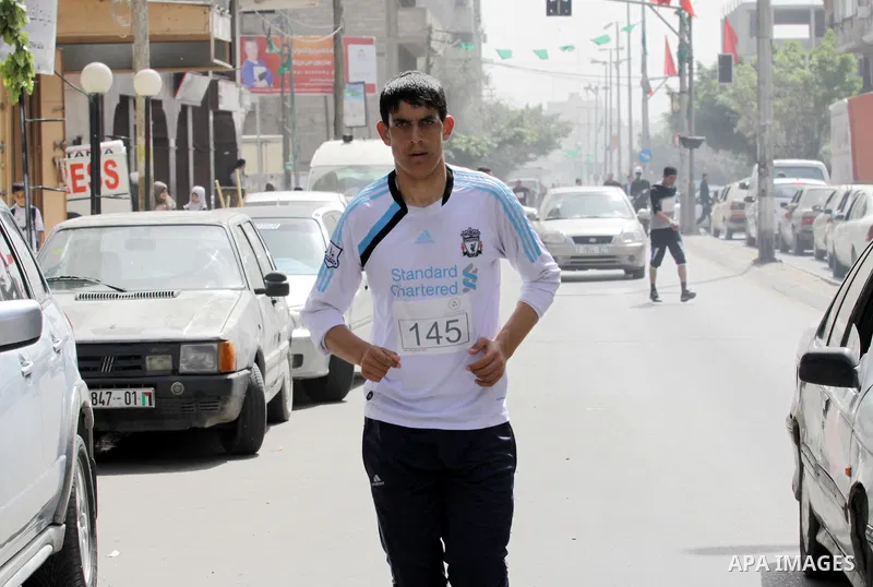 Palestinian youth take part in the symbolic marathon of Jerusalem titled "Freedom for Prisoners" in Gaza City on March 14, 2013 in response to the Jerusalem Marathon which was attended by 20000 racers from 52 countries i...