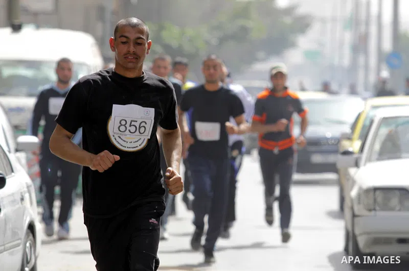 Palestinian youth take part in the symbolic marathon of Jerusalem titled "Freedom for Prisoners" in Gaza City on March 14, 2013 in response to the Jerusalem Marathon which was attended by 20000 racers from 52 countries i...