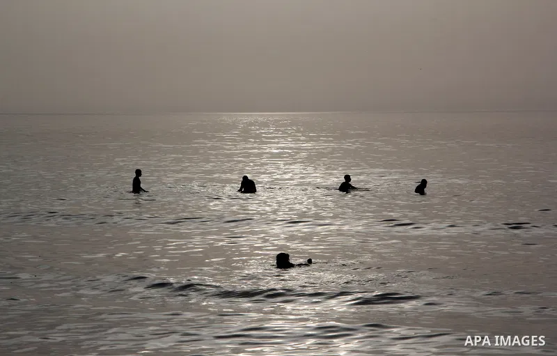 Palestinian children enjoy swimming in the sea at Gaza beach during hot weather in Gaza city, March 15, 2013. The temperature of the Gaza strip reaches more than 30 degrees Celsius, Gazans escape to the beach and out fro...