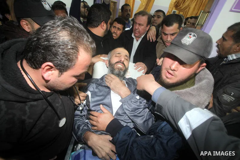 Palestinians carry freed Palestinian prisoner Ayman Sharawna on a stretcher as he gestures upon his arrival to al-Shifa Hospital in Gaza City March 17, 2013. The 36-year-old Ayman Sharawna arrived to Gaza after more than...