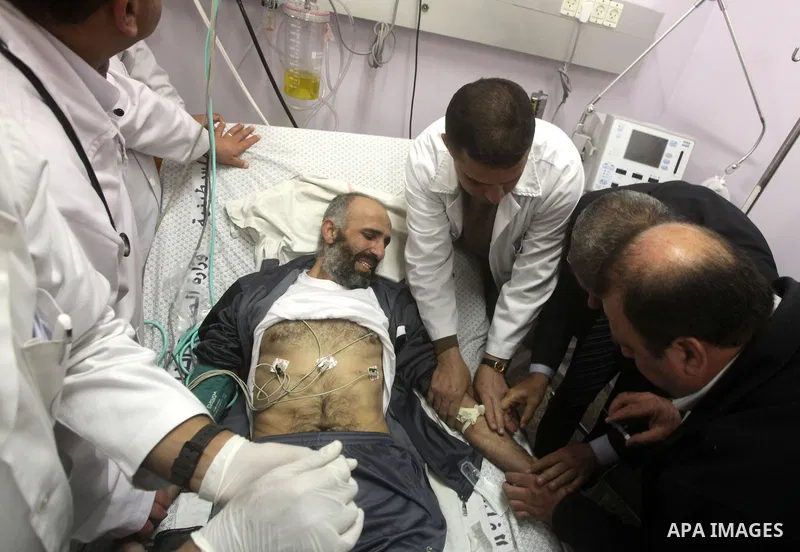 Palestinian medics treat freed Palestinian prisoner Ayman Sharawna upon his arrival to al-Shifa Hospital in Gaza City March 17, 2013. The 36-year-old Ayman Sharawna arrived to Gaza after more than eight months on hunger...