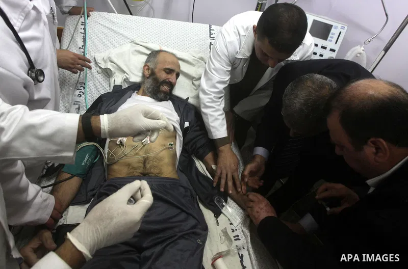 Palestinian medics treat freed Palestinian prisoner Ayman Sharawna upon his arrival to al-Shifa Hospital in Gaza City March 17, 2013. The 36-year-old Ayman Sharawna arrived to Gaza after more than eight months on hunger...