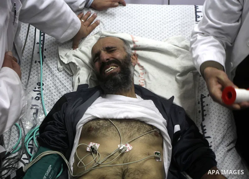 Palestinian medics treat freed Palestinian prisoner Ayman Sharawna upon his arrival to al-Shifa Hospital in Gaza City March 17, 2013. The 36-year-old Ayman Sharawna arrived to Gaza after more than eight months on hunger...