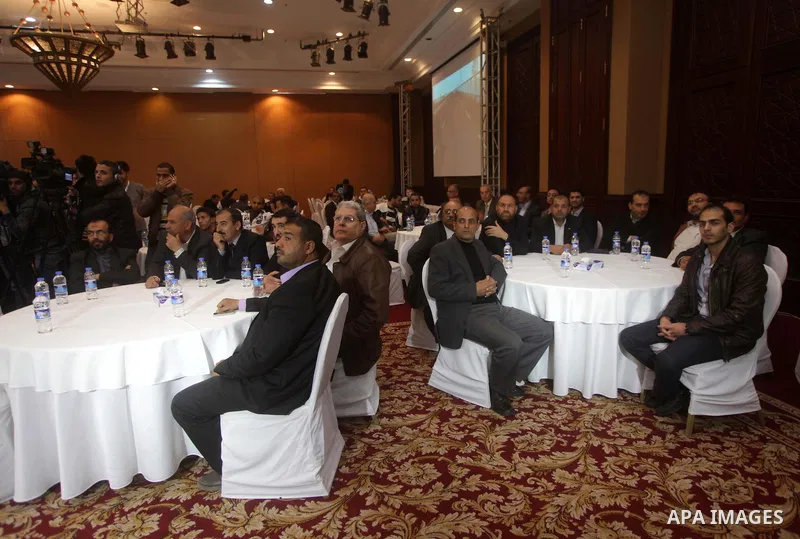Palestinian Minister of Works and Housing in Gaza strip Yousef al-Ghrez, and Qatari ambassador Mohammed al-Emadi (not seen), attend the signing ceremony of agreement to start building the project of Hamad ben Khalifa cit...