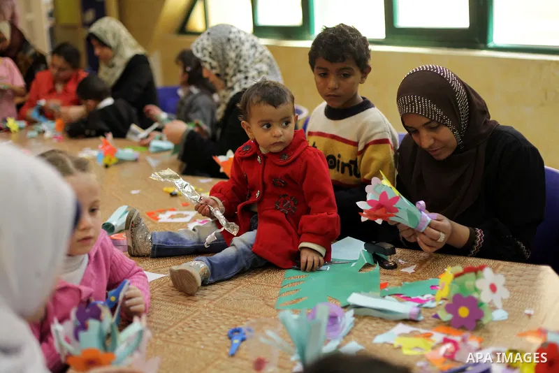 Palestinian women play with their children at a children's cultural center during ''Mother's Day'' in Gaza city, March. 21, 2013. Photo by Ashraf Amra