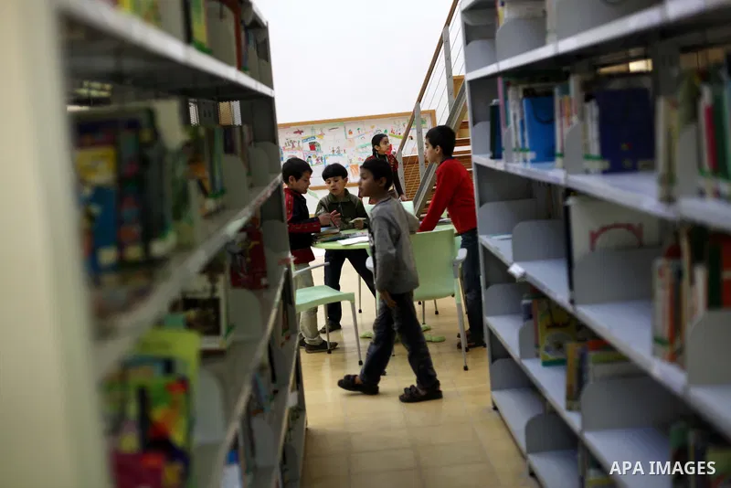 Palestinian children read books at a children's cultural center during ''Mother's Day'' in Gaza city, March. 21, 2013. Photo by Ashraf Amra