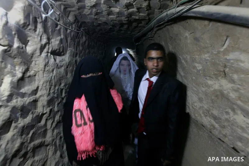 A 21-year-old Palestinian groom Imad, walks with his bride Manal, 21-year-old, in a smuggling tunnel between the southern Gaza Strip and Egypt in the border town of Rafah on March 21, 2013. Imad forced to marry his Egypt...
