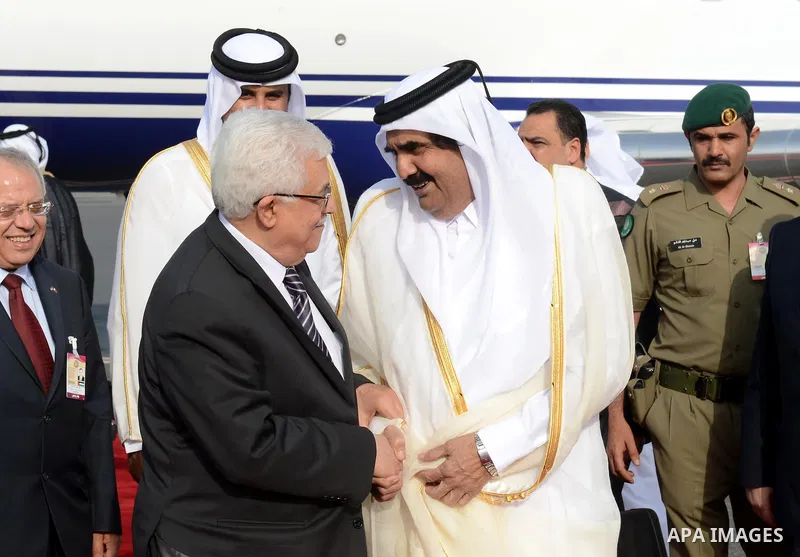 Palestinian President Mahmoud Abbas meets with the Emir of Qatar Hamad Bin Khalifa Al-Thani upon his arrival to Qatar ahead of the annual Arab League summit in the Qatari capital Doha on March 24, 2013. Qatar, the small...