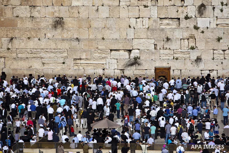 Ultra-Orthodox Jews pray in front of the Western Wall, Judaism's holiest site, as they recite the Priestly Blessing, a special prayer performed twice a year, in Jerusalem, 28 March 2013, during the high holiday of Passov...